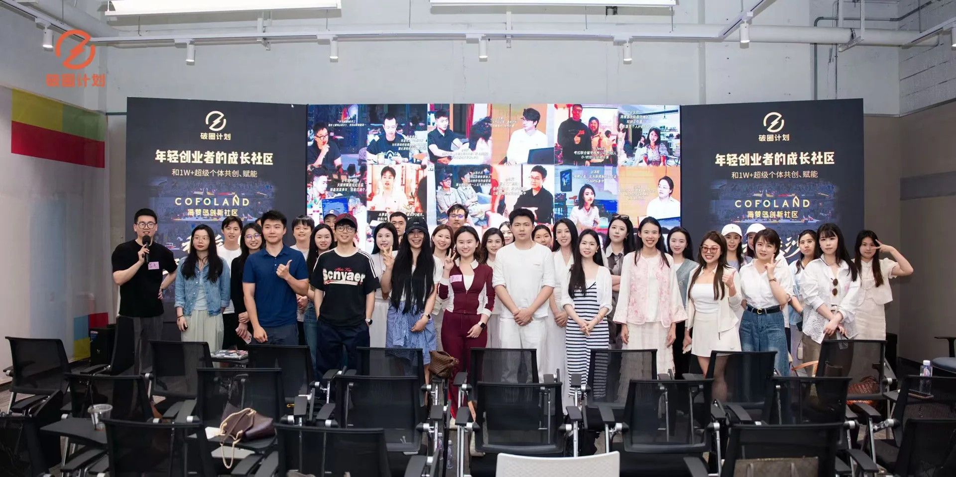 破圈活动现场,创业者在路演厅品牌背景前合影
